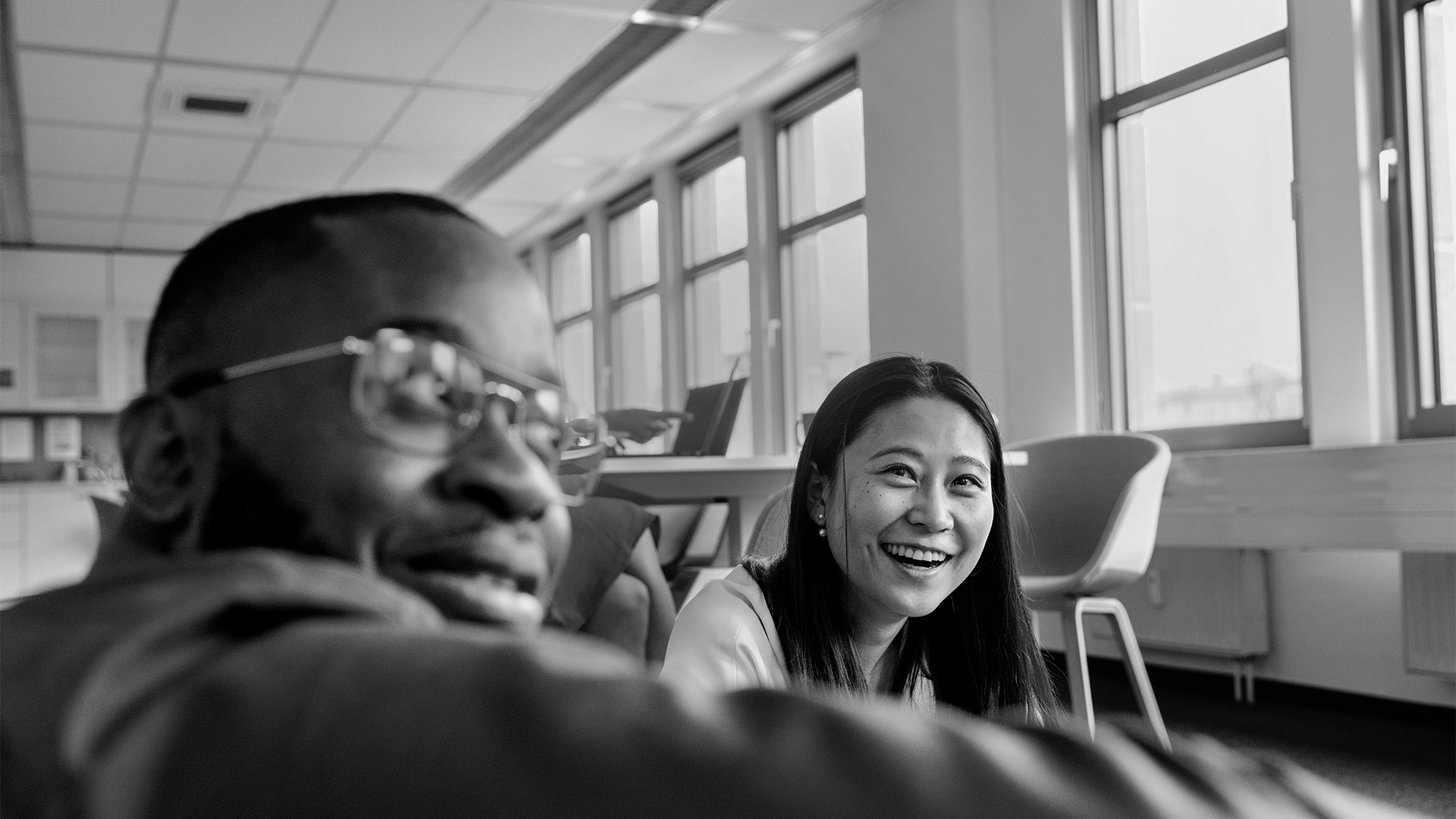 man and woman sitting together and laughing